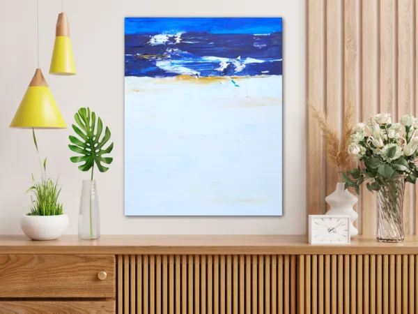 Original Wave Art with blue, yellow, and white hung above a brown console